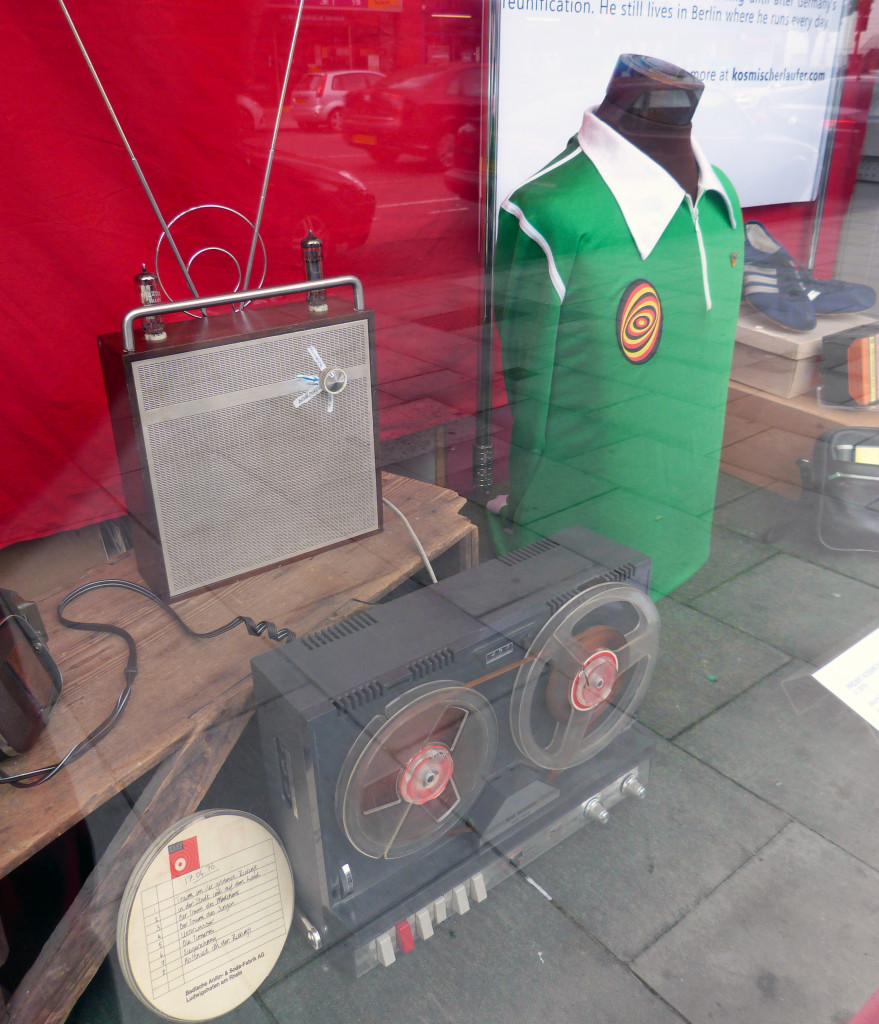 Window display including a radio receiver made by Martin Zeichnete's father in the 1950s and a 1970's reel to reel machine used by Zeichnete to record broadcasts from the West.